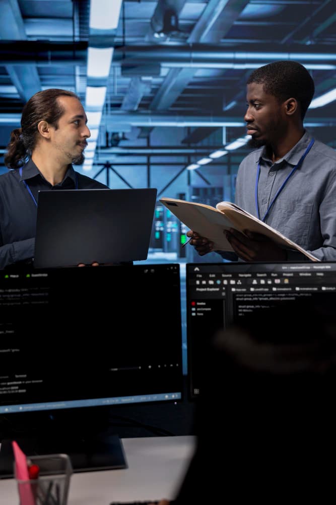Manufacturing team reviewing data on screens