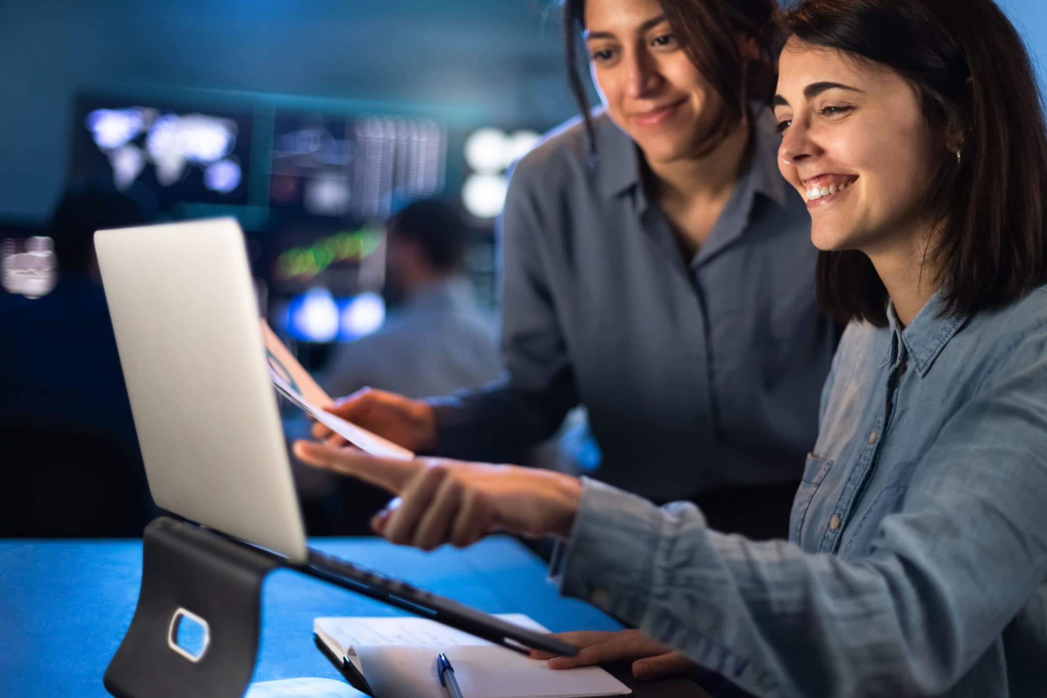 People analyzing data on monitors